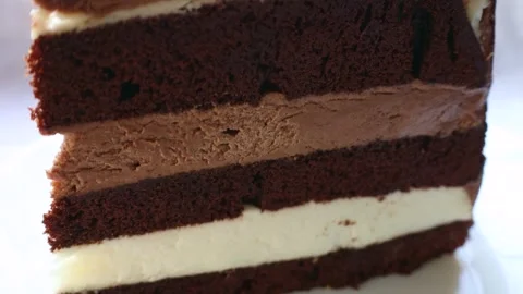 Triple chocolate cake piece circle rotation close up Stock Footage 264966722