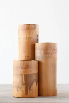 Triple dry bamboo segment oon wooden table Stock Photos