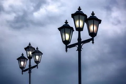Triple lantern 3 head with transparent glass panels and electric bulb. Stock Photos