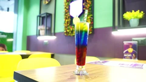 Triple layer Mocktail in Indian Cafe close up scene with blur background. Stock Footage 248080153