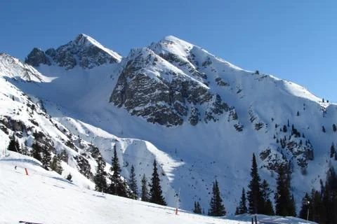 Triple peak under a snow blanket. Alps Austria Stock Photos