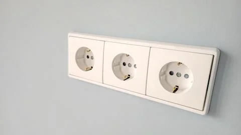 Triple socket on the wall. New sockets after indoor renovation Stock Photos