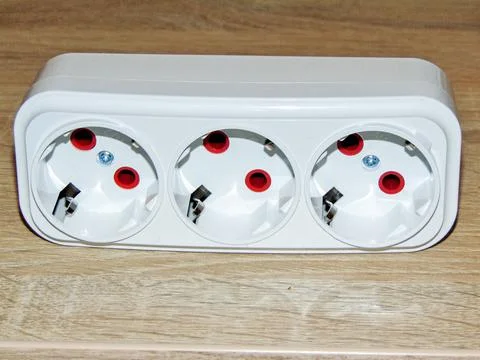 Triple socket on a wooden background 스톡 사진