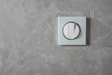 Triple wall light switch on a gray wall 写真素材