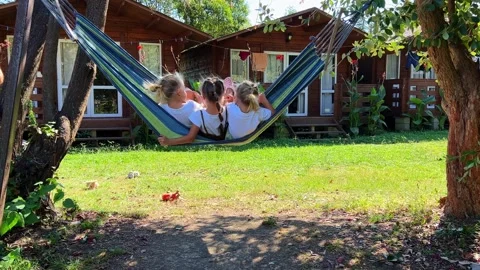 Triplets Sisters swinging on a hammock Vidéo 252490826