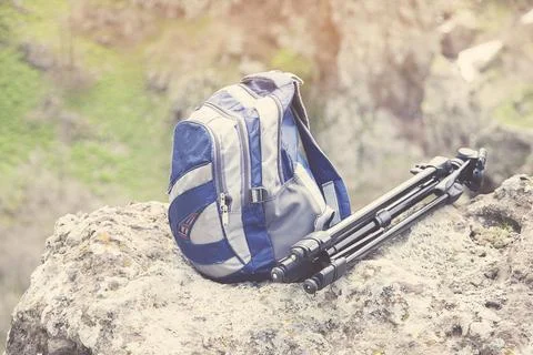 Tripod and backpack Stock Photos