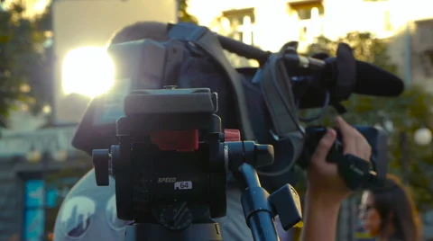 Tripod on the background of the operator with a professional camera Stock Footage 66878428