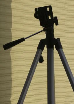 A tripod for a camera. A tripod in the original perspective. Stock Photos