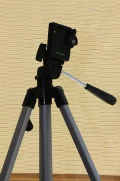 A tripod for a camera. A tripod in the original perspective. Stock Photos
