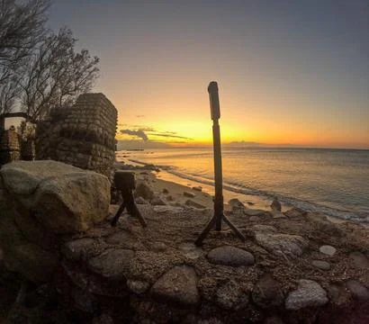 On the tripod in front of the Mediterranean sunset Stock Photos