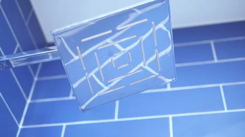 Tripod: Opening shower stream in a bathroom, blue tiles background, close up Stock-Footage 90652303
