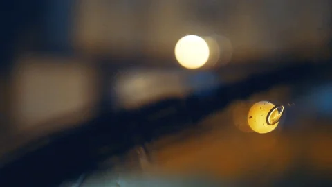 Tripod: Rain dropping on a windshield, wipers on, close up Stock-Footage 90894584