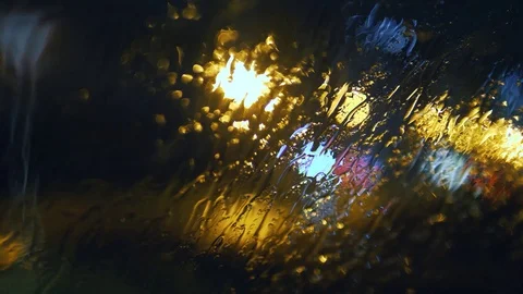 Tripod: Rain dropping on a windshield, wipers on, blurry night city background Stock-Footage 90894634