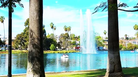 Tripod Shot between Two Trees while Water Fountain is in background. Stock Footage 85458448