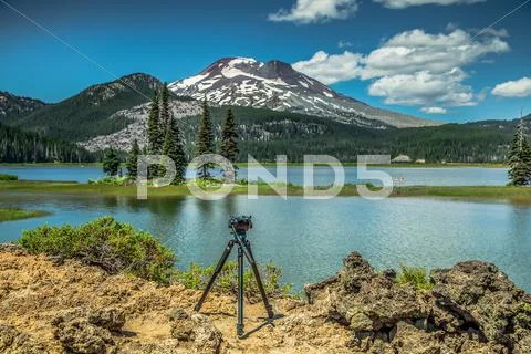 Tripod sitting by a mountain lake Stock Photos