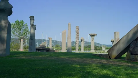 Tripod Still of Stone Monolith Circle on Green Field by Lake at Sunset Stock Footage 315850314