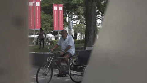 Trishaw uncle out of focus rack move left to right day Stock Footage 230567096