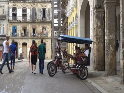 Trishaws without passengers are parked on central touristic street near square Stock Footage 70856668