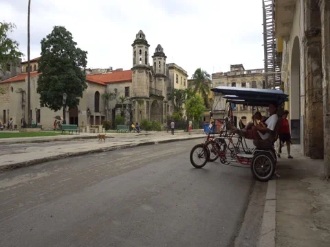 Trishaws without passengers are parked on central touristic street near square Stock Footage 70856680