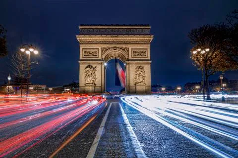 Triumph arc, Arc de Triomphe in French,  place at the blue hours crowded with Фото