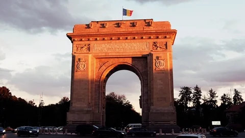 Triumphal arch and flag at sunset red light and purple sky Stock Footage 112873168