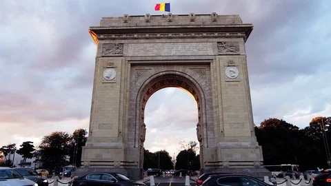 Triumphal arch and flag at sunset red light and purple sky Stock Footage 112873175