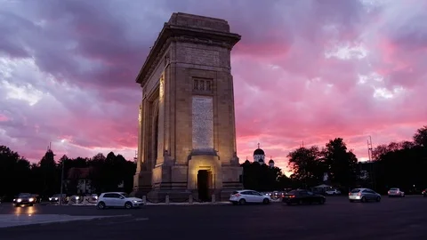 Triumphal arch and flag at sunset red light and purple sky Stock Footage 112873651