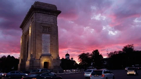 Triumphal arch and flag at sunset red light and purple sky Stock Footage 112873817