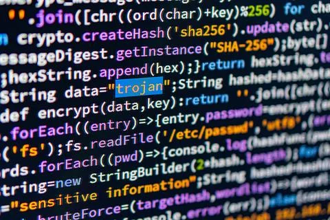 Trojan. A close-up of a computer screen displaying colorful text with encry.. 스톡 사진