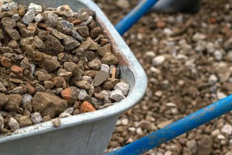 Trolley for building material. Distribution of rubble on the road. Stock Photos