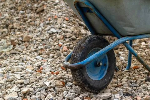 Trolley for building material. Distribution of rubble on the road. Stock Photos