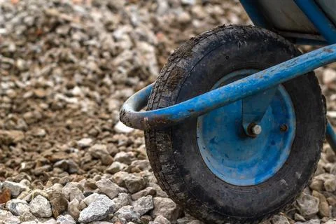 Trolley for building material. Distribution of rubble on the road. Stock Photos