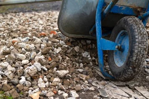 Trolley for building material. Distribution of rubble on the road. Stock Photos