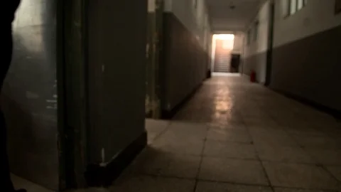 Trolley full of books being pulled along dark corredor Stock Footage 77337944