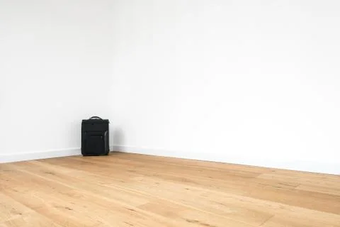 Trolley, rolling suitcase in empty  room Stock Photos