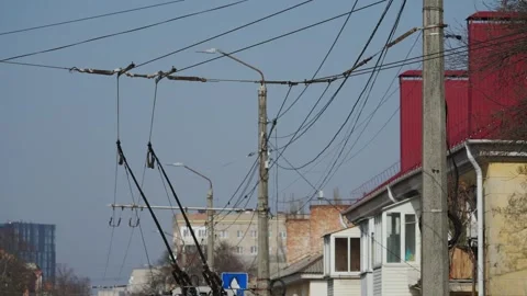 Trolleybus passes bend of wire, turns at intersection Stock Footage 304577111