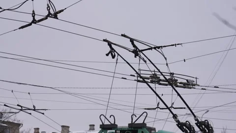 Trolleybus passes through trolley contact lines against sky.  Stock Footage 328645672