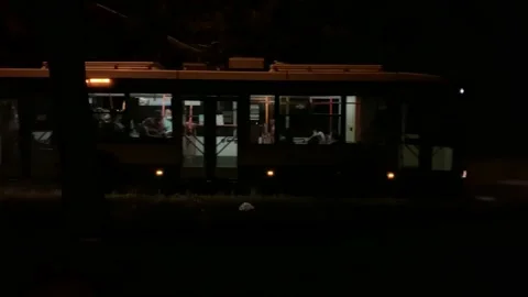 Trolleybus with people going slowly in complete darkness at night Stock Footage 146799460