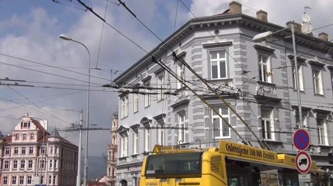 Trolleybus rapidly passing catenary wire curve elements in the city center Stock Footage 64694734