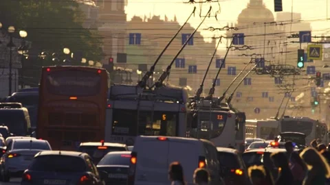 Trolleybuses move slowly in a traffic while pedestrians cross Nevsky Prospect Stock-Footage 146979381