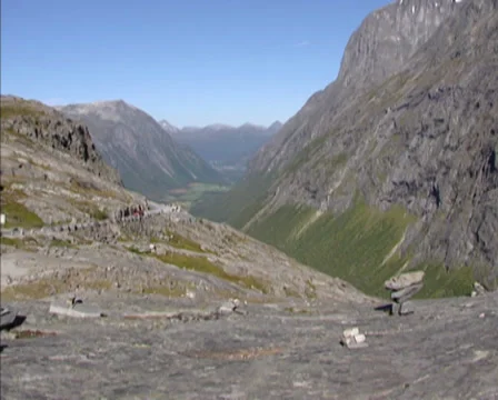 TROLLSTIGEN, NORWAY - (Troll path) Valley + pan stone piles on a flat rock Stock-Footage 38520462