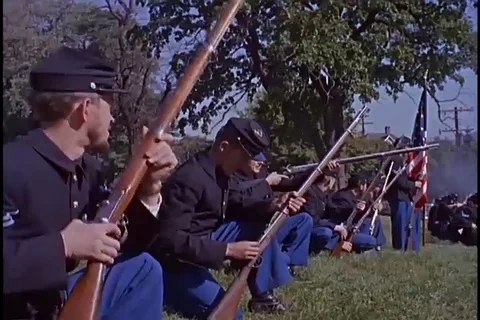 Troop firing on fire engine house during Harpers Ferry events reenactment - 1959 Video stock 105757633