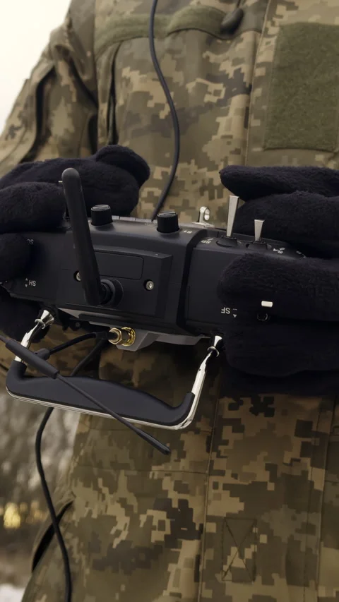 Troop in gloves holds remote control of drone as operating aircraft Stock Footage 323843657