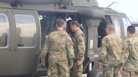 Troops boarding Black Hawk to deliver water to survivors of Hurricane Maria Stock-Footage 81705959