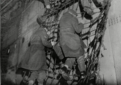 Troops Climbing Down A Scrambling Net On The Empress Of Scotland And Fought Thei Stock Photos