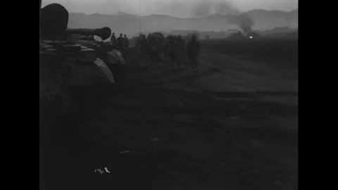 Troops march down a road and tanks are shown at Hungnam Harbor during the Korean Stock Footage 100556974