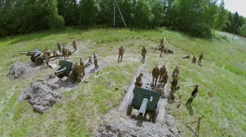 Troops in uniform of Soviet Army of World War II stand near guns Stock Footage 44541371