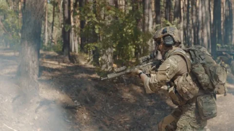 Troops of US army with rifles take shooting positions in the forest Stock Footage 93983455