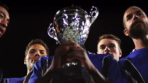 A trophy being held in the air by a sports team Stock Footage