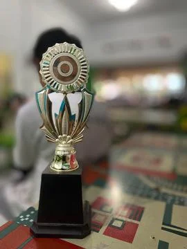 A trophy lies on a table with a blurred background Stock Photos